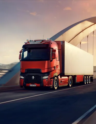 Renault Trucks T High on the highway at sunrise with LED bars on the roof rack.